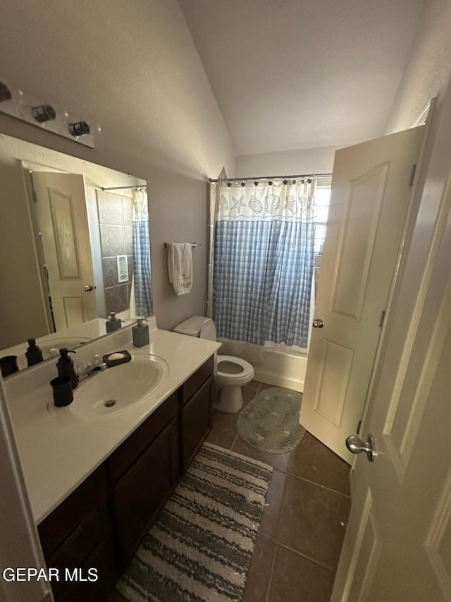 bathroom featuring tile patterned flooring, vanity, shower / bathtub combination with curtain, toilet, and lofted ceiling