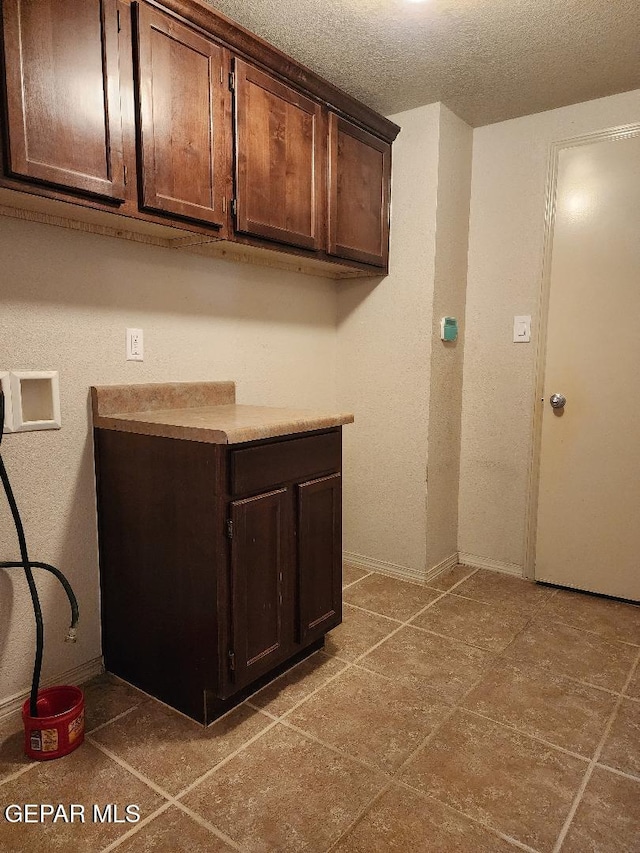 5488 Francisco Roque Dr, El Paso, TX 79934 - laundry room featuring cabinet space, hookup for a washing machine, and a textured ceiling
