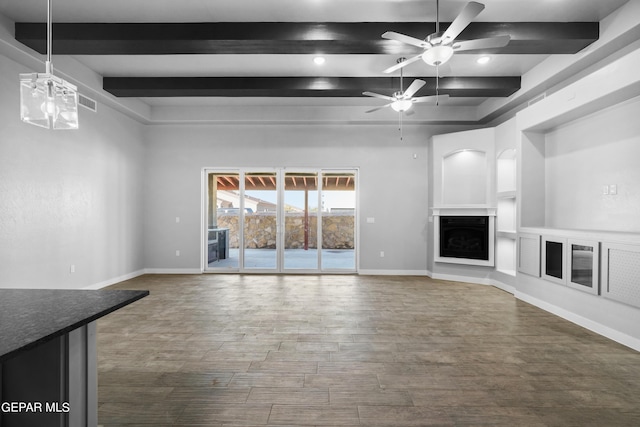 unfurnished living room featuring beamed ceiling, a ceiling fan, wood finished floors, baseboards, and recessed lighting