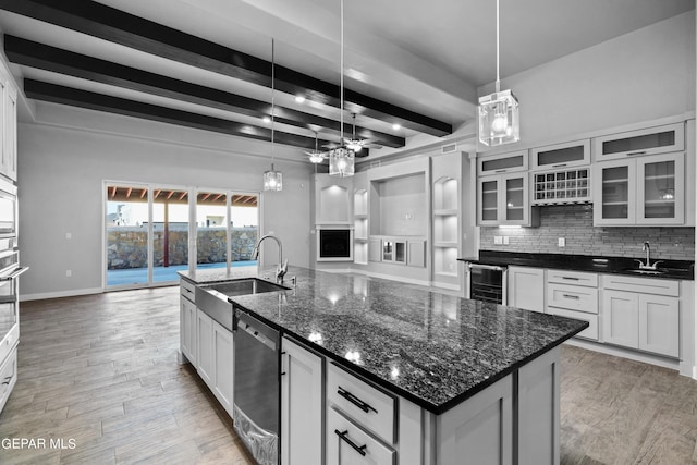 kitchen featuring a sink, beverage cooler, dishwasher, beam ceiling, and tasteful backsplash