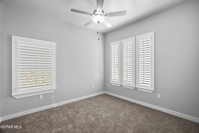 spare room featuring carpet, ceiling fan, and baseboards