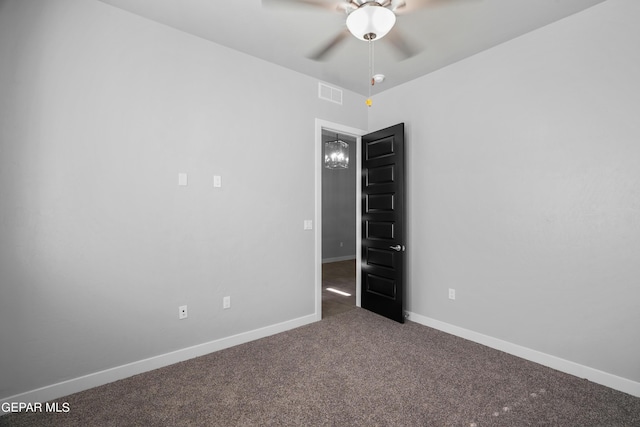 unfurnished room featuring a ceiling fan, carpet floors, and baseboards