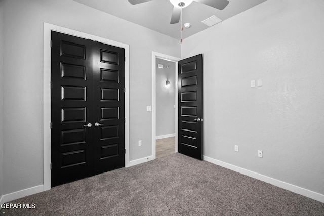 unfurnished bedroom featuring carpet, baseboards, and a ceiling fan