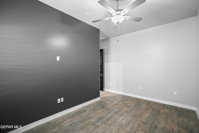 unfurnished room featuring a ceiling fan, wood finished floors, and baseboards