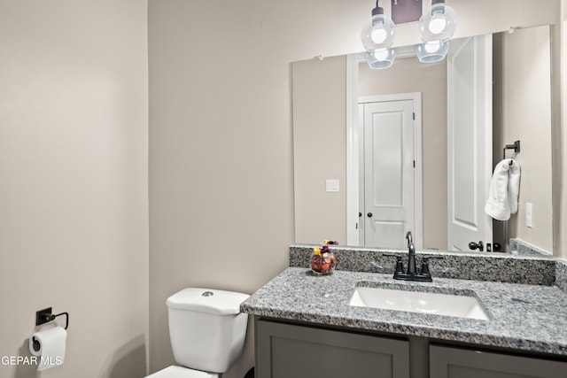 bathroom with toilet and vanity