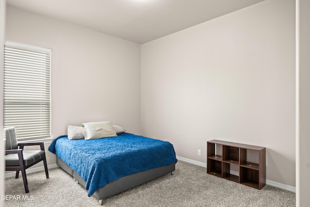 carpeted bedroom with baseboards