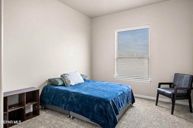 bedroom featuring carpet flooring and baseboards