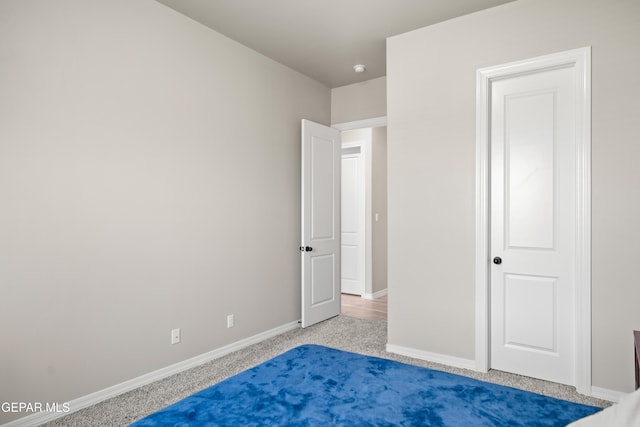 unfurnished bedroom featuring baseboards and carpet flooring
