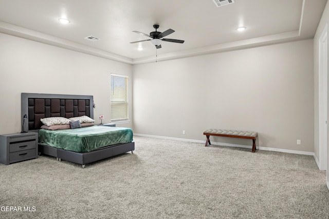 carpeted bedroom featuring a raised ceiling, baseboards, ceiling fan, and recessed lighting