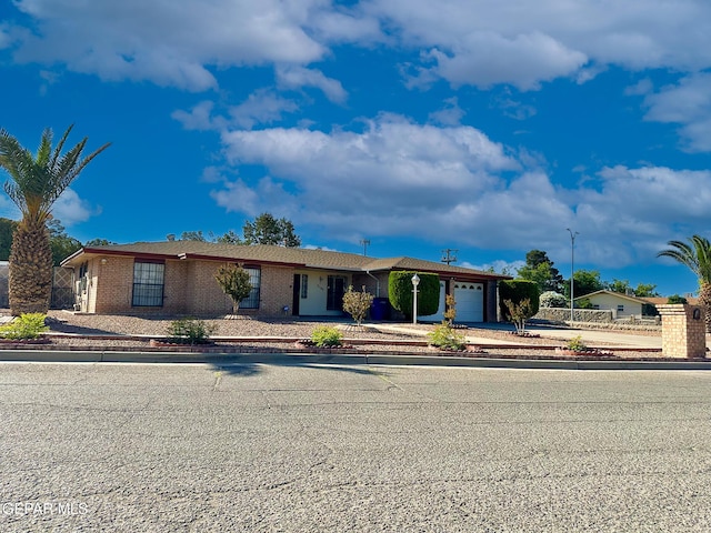 3100 Hector Dr, El Paso, TX 79935 - ranch-style house featuring an attached garage, concrete driveway, and brick siding