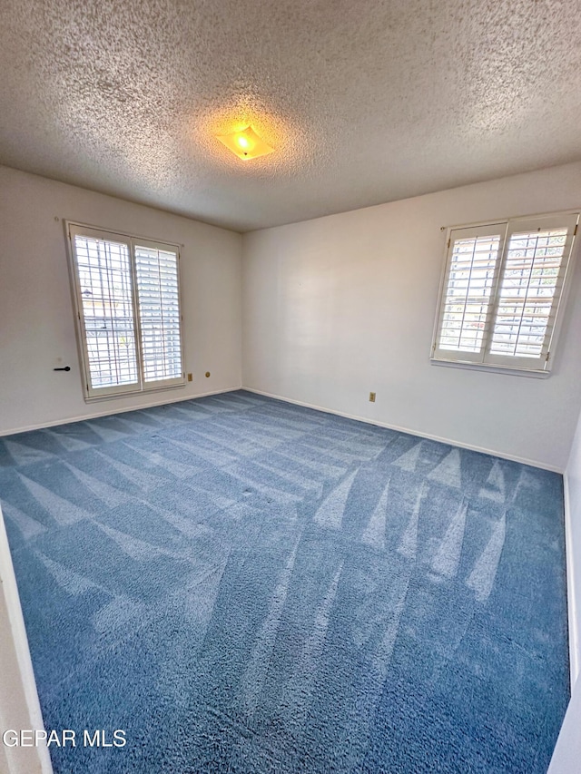3100 Hector Dr, El Paso, TX 79935 - carpeted spare room featuring a textured ceiling and baseboards