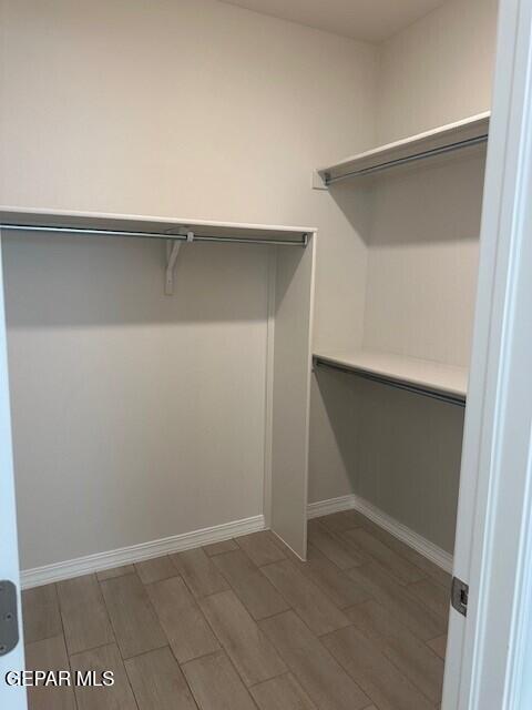 6112 Hidden Row Ave, El Paso, TX 79924 - walk in closet with light wood-style floors