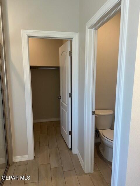 6112 Hidden Row Ave, El Paso, TX 79924 - bathroom with tile patterned floors, toilet, and baseboards
