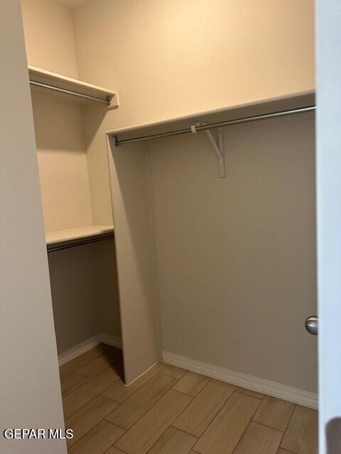 6112 Hidden Row Ave, El Paso, TX 79924 - walk in closet featuring wood tiled floors