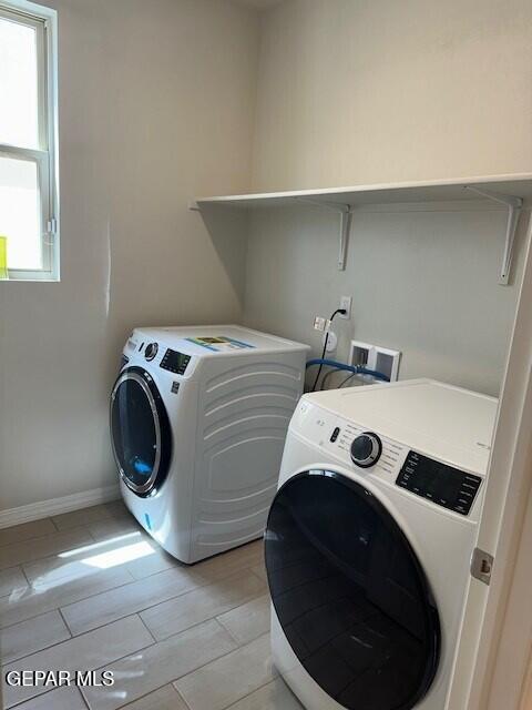 6112 Hidden Row Ave, El Paso, TX 79924 - laundry room with washer and clothes dryer and baseboards