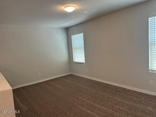 6112 Hidden Row Ave, El Paso, TX 79924 - empty room with dark colored carpet and baseboards