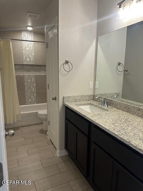 6112 Hidden Row Ave, El Paso, TX 79924 - bathroom featuring shower / bath combination with curtain, vanity, and toilet