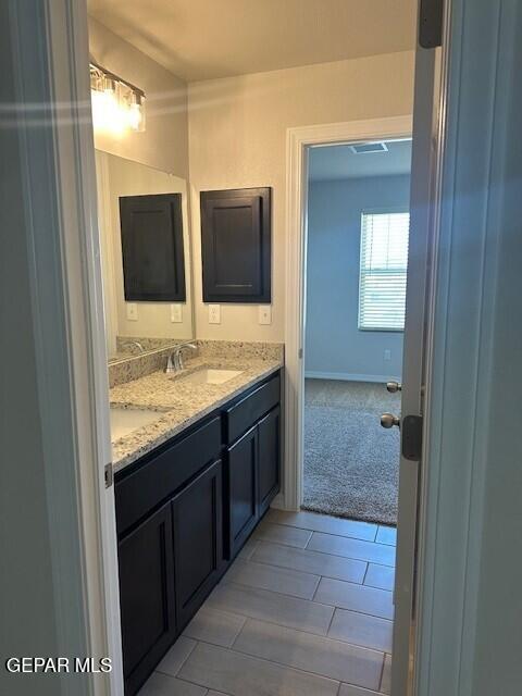 6112 Hidden Row Ave, El Paso, TX 79924 - bathroom featuring double vanity and tile patterned flooring