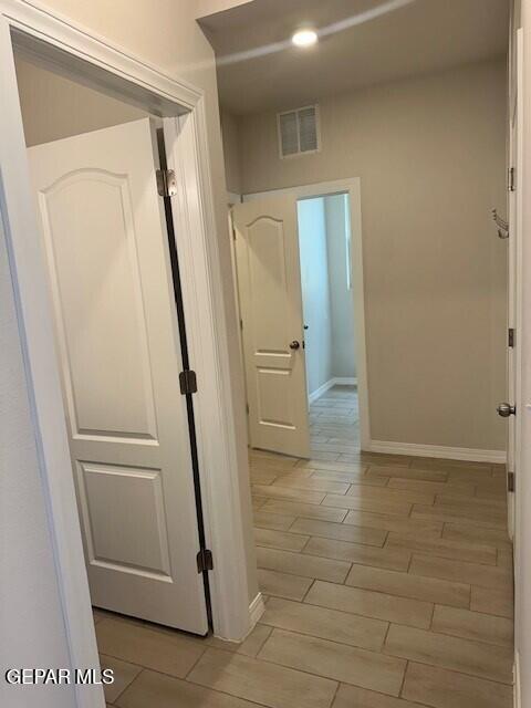 6112 Hidden Row Ave, El Paso, TX 79924 - hallway featuring baseboards and wood finish floors