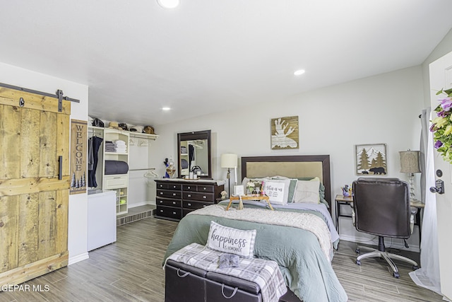 3244 Richmond Ave, El Paso, TX 79930 - bedroom featuring wood finished floors, baseboards, recessed lighting, and a barn door
