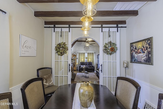 3244 Richmond Ave, El Paso, TX 79930 - dining space with a barn door, beam ceiling, arched walkways, and a ceiling fan