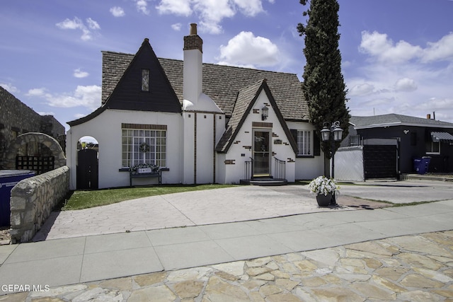 3244 Richmond Ave, El Paso, TX 79930 - view of front of house featuring driveway, stucco siding, and a chimney