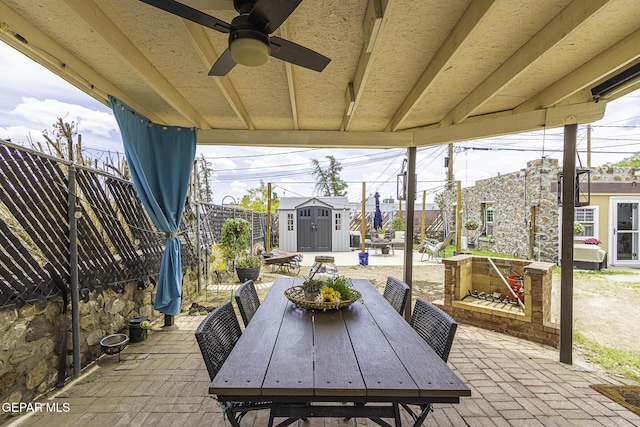3244 Richmond Ave, El Paso, TX 79930 - view of patio / terrace with a storage shed, an outdoor structure, outdoor dining space, a ceiling fan, and a fenced backyard
