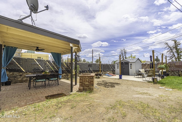 3244 Richmond Ave, El Paso, TX 79930 - fenced backyard featuring a storage unit, a patio area, ceiling fan, an outbuilding, and outdoor dining area