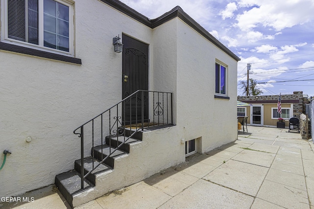 3244 Richmond Ave, El Paso, TX 79930 - doorway to property featuring stucco siding and a patio