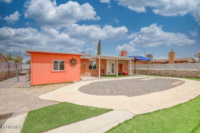 ranch-style house with fence and a patio area