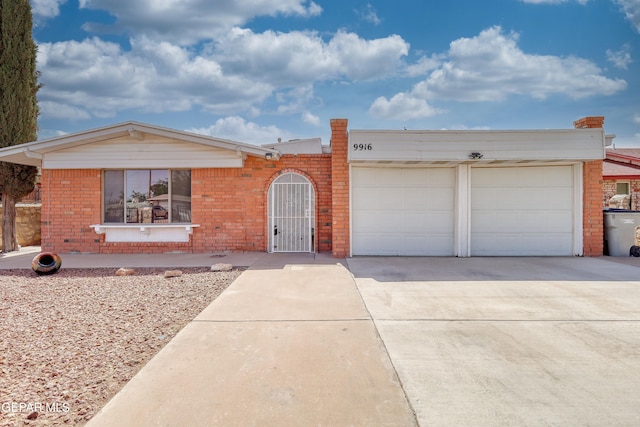 ranch-style house with brick siding, driveway, and an attached garage