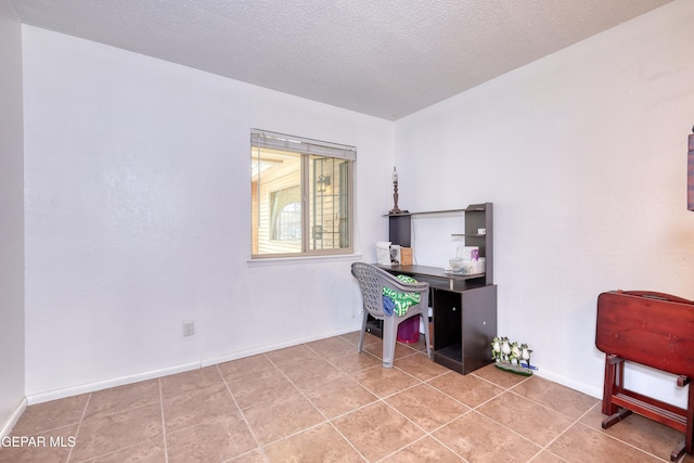 tiled office with baseboards and a textured ceiling