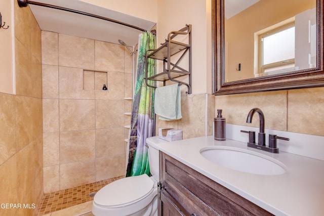 bathroom featuring a stall shower, vanity, toilet, and tasteful backsplash