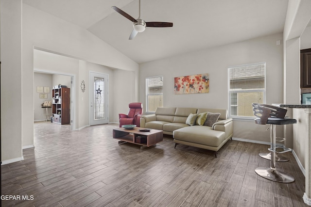 7421 Dewberry Dr, El Paso, TX 79911 - living room featuring healthy amount of natural light, wood finished floors, ceiling fan, baseboards, and high vaulted ceiling