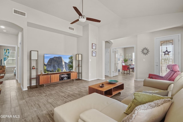 7421 Dewberry Dr, El Paso, TX 79911 - living area with arched walkways, ceiling fan, wood finished floors, and baseboards