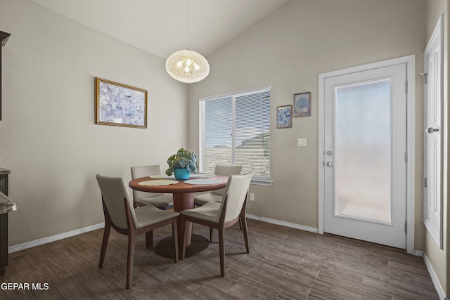 7421 Dewberry Dr, El Paso, TX 79911 - dining room featuring vaulted ceiling, dark wood-style flooring, plenty of natural light, and a chandelier