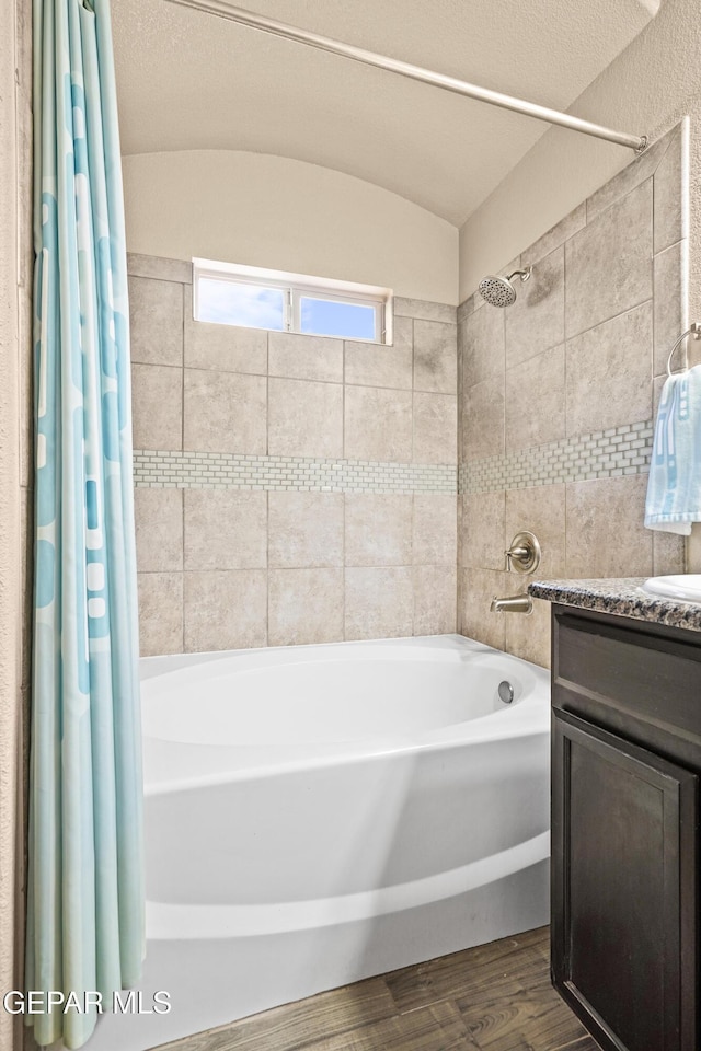 7421 Dewberry Dr, El Paso, TX 79911 - full bathroom with shower / tub combo, vanity, and wood finished floors