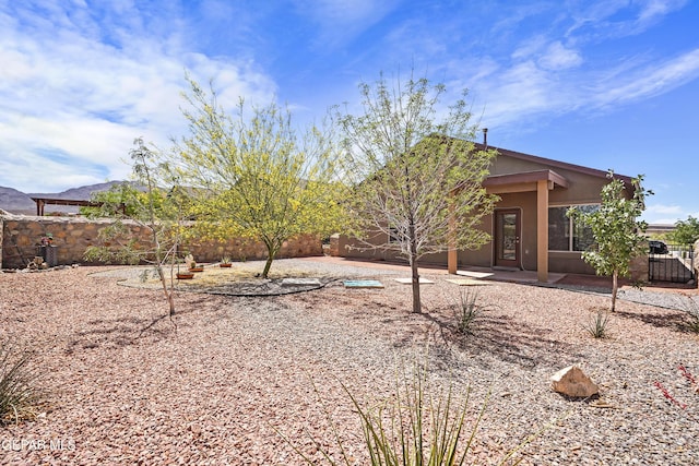 7421 Dewberry Dr, El Paso, TX 79911 - back of property with a fenced backyard and a patio