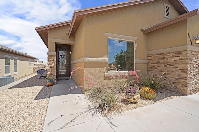 7421 Dewberry Dr, El Paso, TX 79911 - doorway to property with stucco siding and central AC