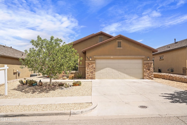 7421 Dewberry Dr, El Paso, TX 79911 - view of front of home featuring stucco siding, driveway, stone siding, and a garage