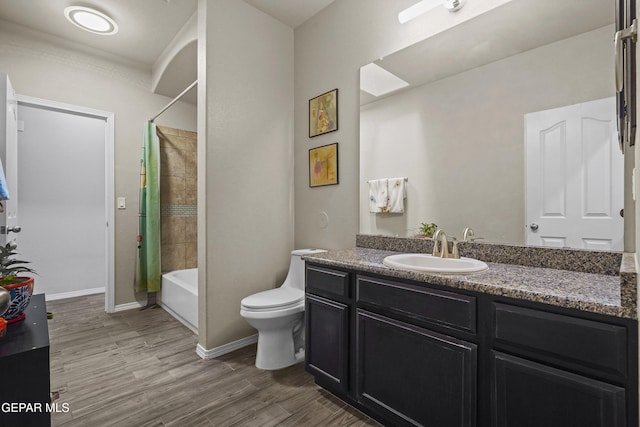 7421 Dewberry Dr, El Paso, TX 79911 - bathroom featuring vanity, wood finished floors, toilet, shower / bath combination with curtain, and baseboards