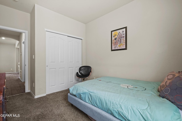 7421 Dewberry Dr, El Paso, TX 79911 - carpeted bedroom with arched walkways, a closet, and baseboards