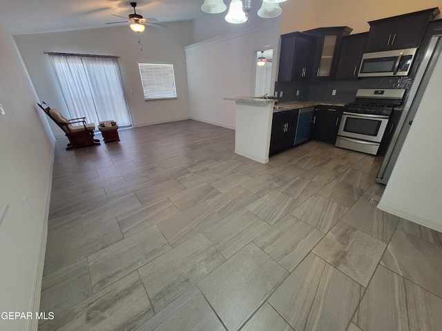 13611 Everingham St, El Paso, TX 79928 - kitchen with appliances with stainless steel finishes, a ceiling fan, a peninsula, open floor plan, and tasteful backsplash