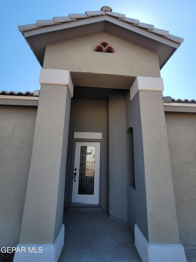 13611 Everingham St, El Paso, TX 79928 - view of exterior entry featuring stucco siding and a tile roof