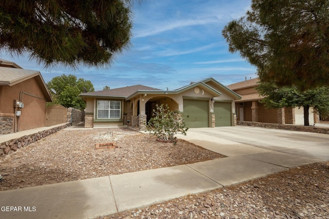 ranch-style home featuring a garage, stucco siding, concrete driveway, fence, and stone siding