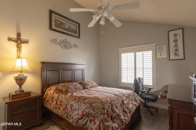 bedroom with wood finished floors, vaulted ceiling, baseboards, and ceiling fan