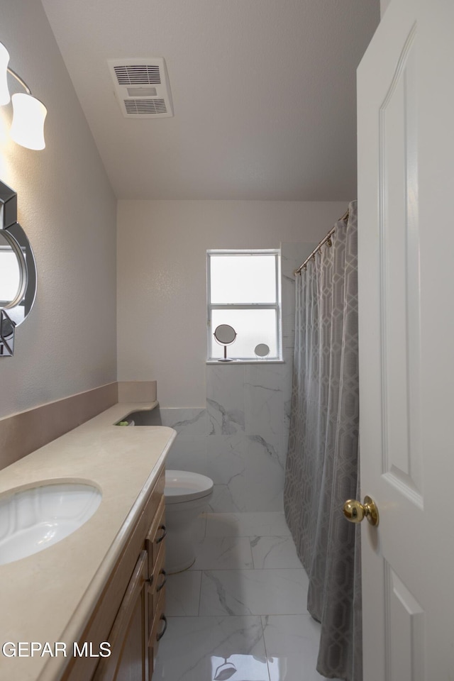 bathroom featuring marble look tiles, vanity, curtained shower, and toilet