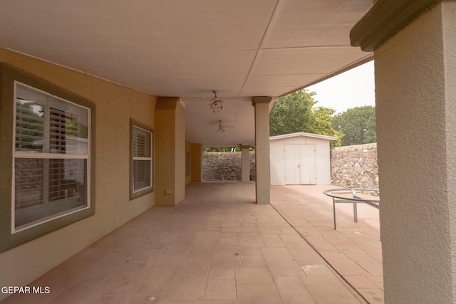 view of patio / terrace featuring a storage unit and an outdoor structure