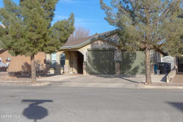 ranch-style home featuring concrete driveway and an attached garage