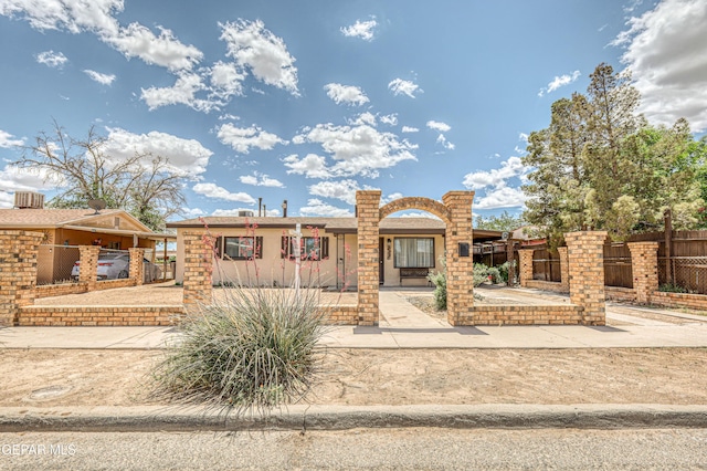 view of front of property with fence and stucco siding